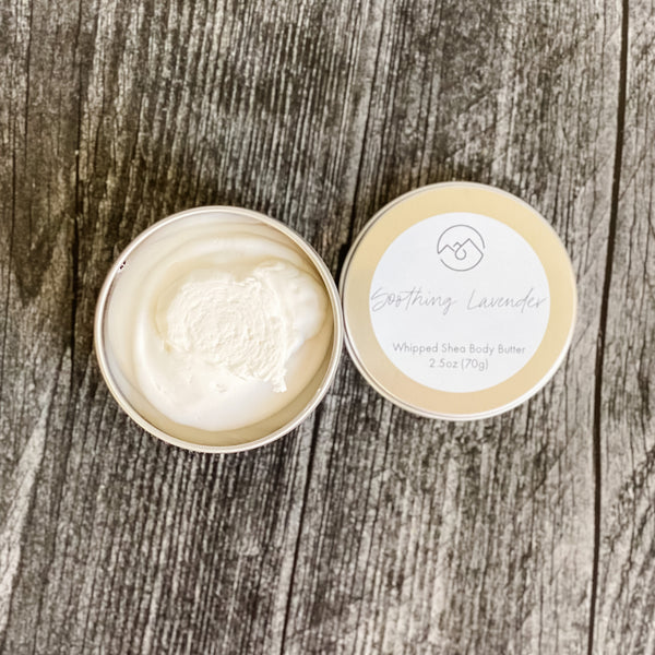Soothing Lavender Whipped Body Butter in tin with lid next to it. Shows the creamy whipped nature of this body butter.