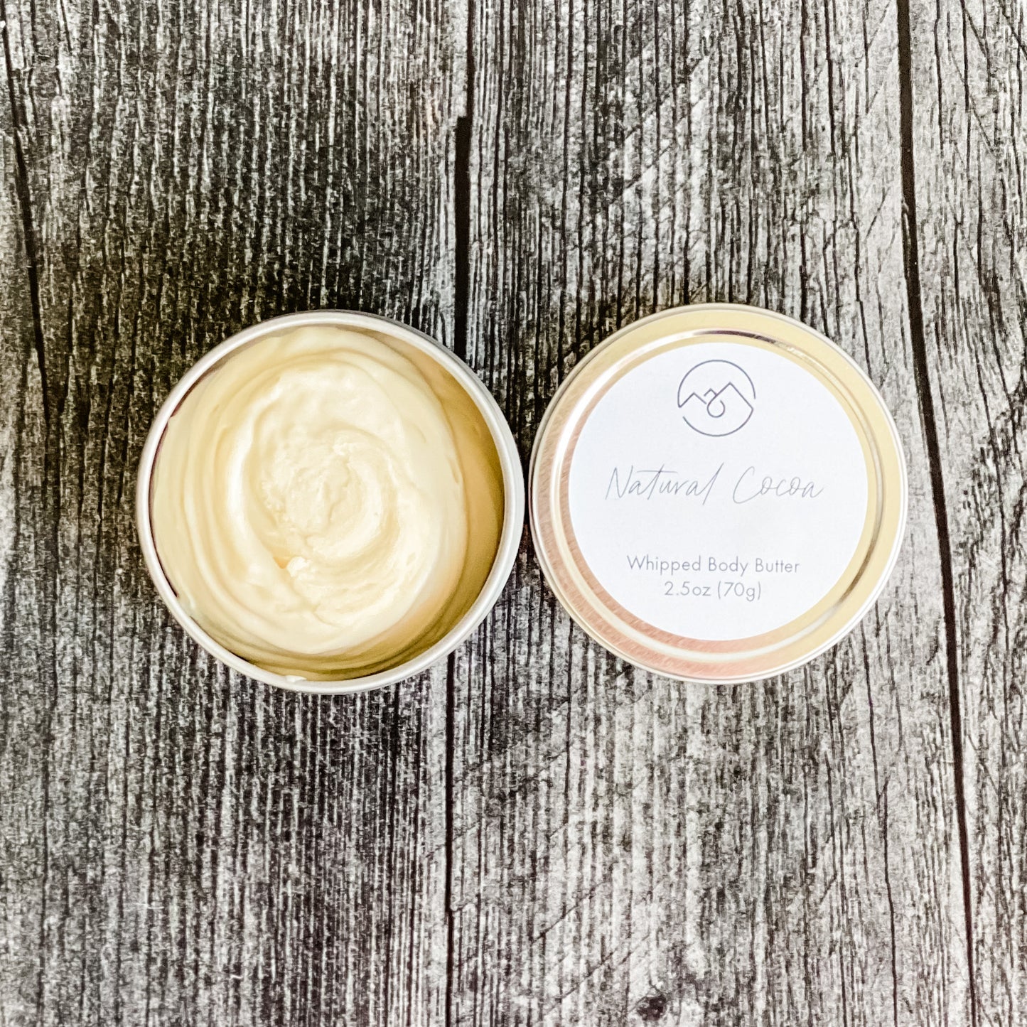 Natural Cocoa Whipped Body Butter in tin with lid next to it. Shows the creamy whipped nature of this body butter.